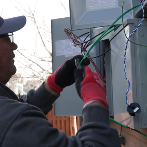 Master Electrician working on wiring for solar panel installation by Elite Solar Solutions in Denver, CO